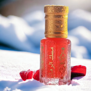 Glass bottle of Sandalwood Musk perfume oil with red sandalwood chips and wooden spoon – alcohol-free natural fragrance for hair and body