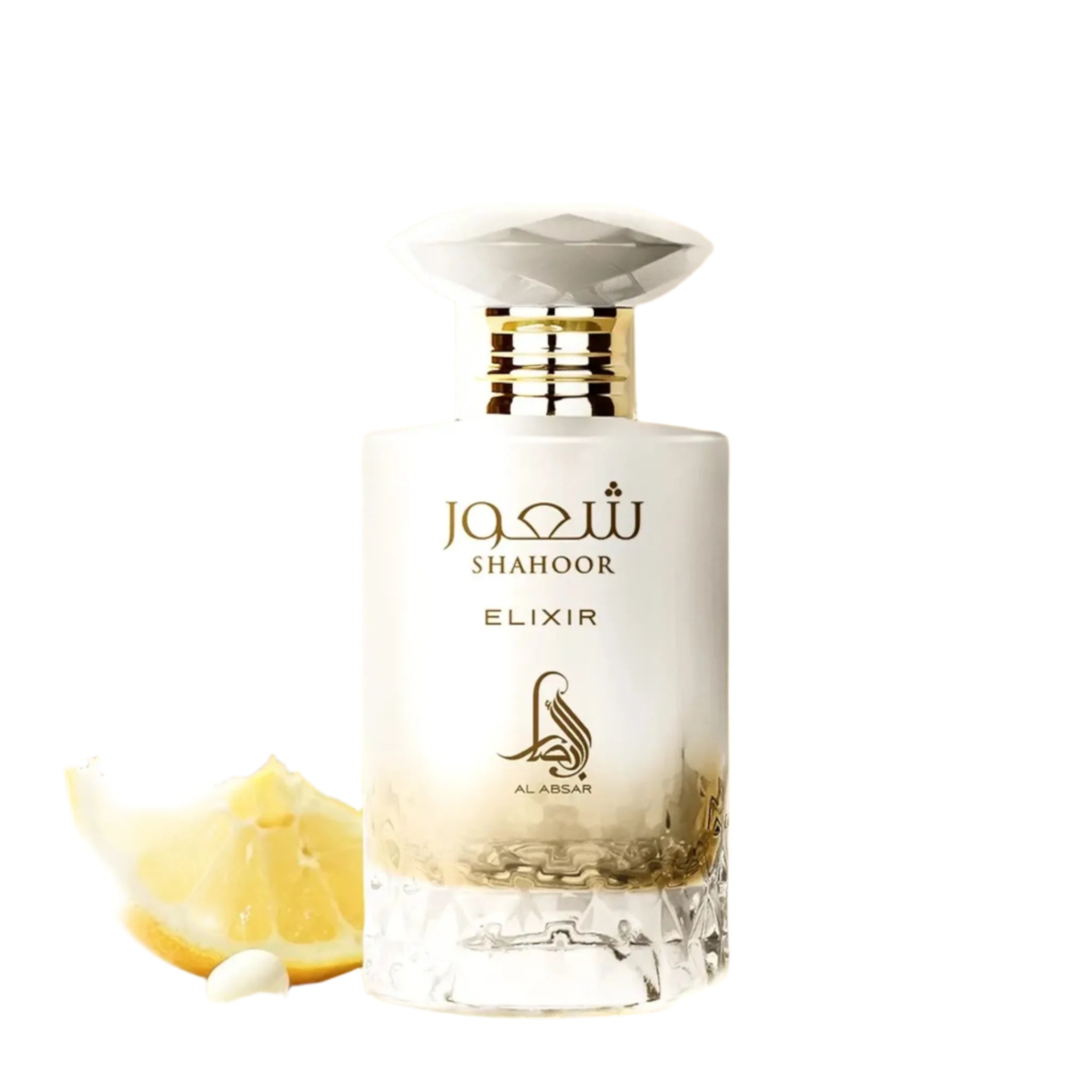 A bottle of Al Absar Shahoor elixir perfume with top notes listed as lemon, candy, and rum, middle notes as orange blossom and milk, and base notes as vanilla, benzoin, amber, and musk, presented alongside slices of lemon and a bar of soap.
